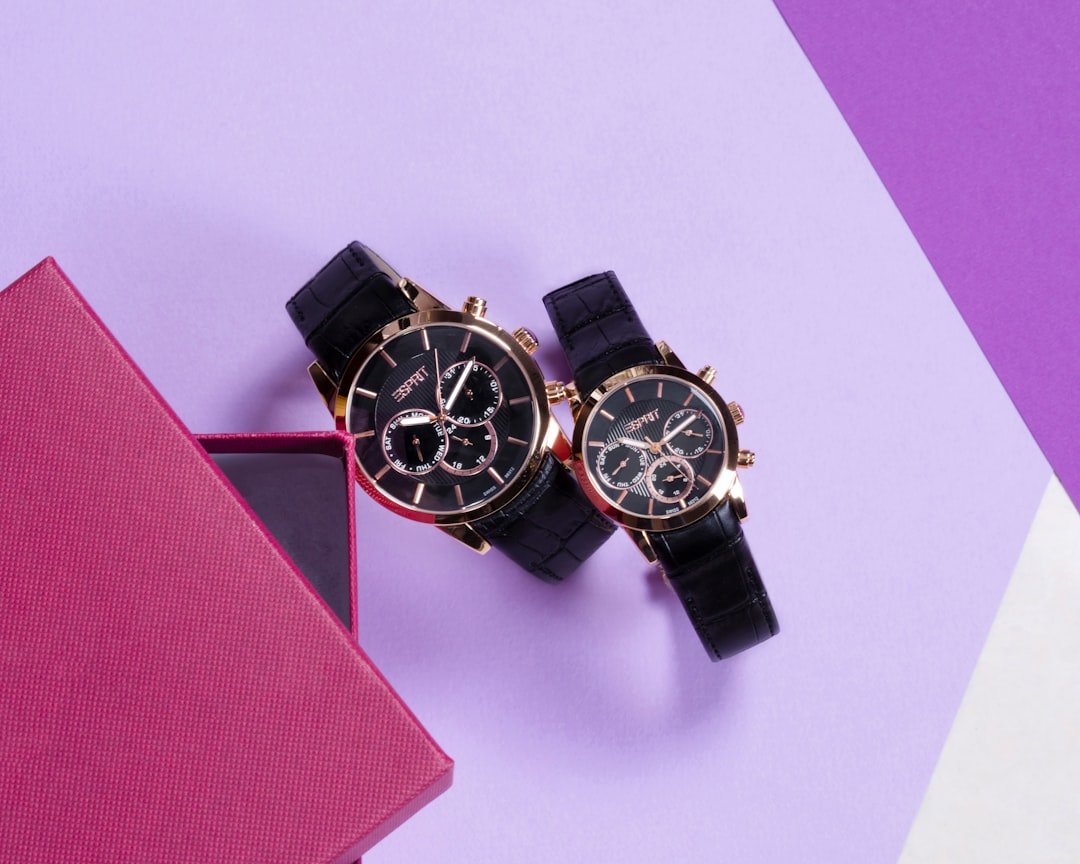 Stylish unisex watch with interchangeable straps on wooden display